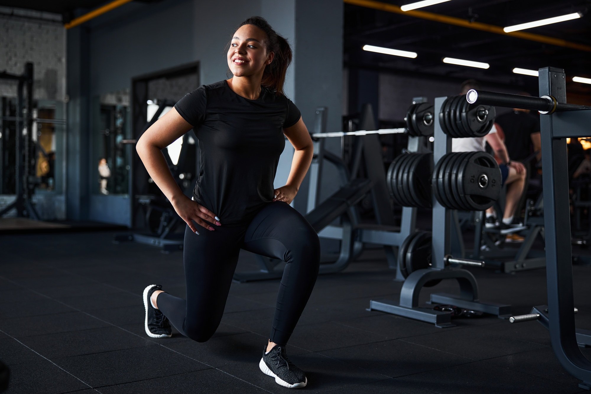 Happy young woman enjoying bodyweight training indoors