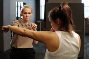 What to Expect in a Women’s Self-Defense Class? 1 Instructor demonstrating women’s self-defense techniques during a class at MCWandMA in Morris County